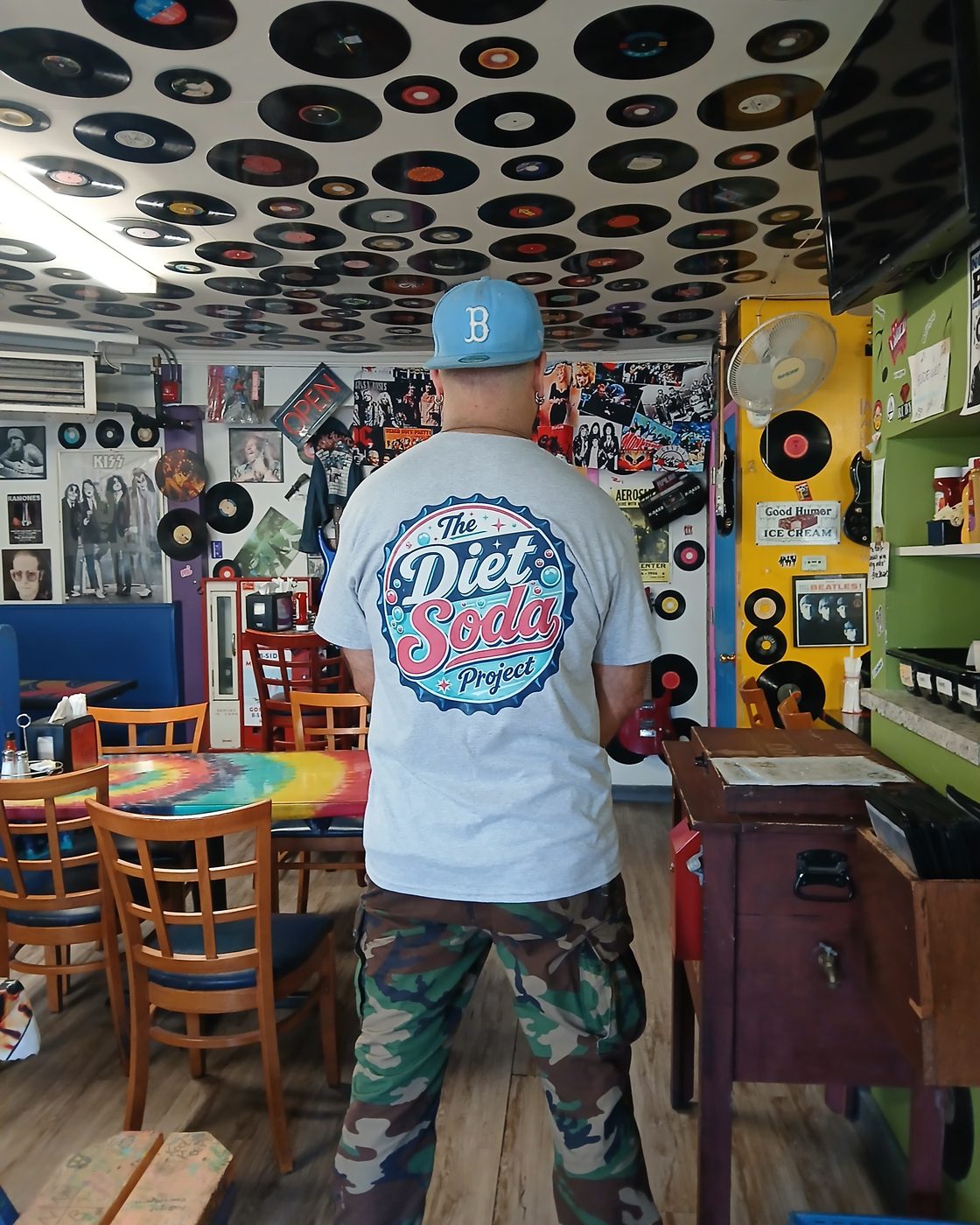 Lou wearing the Diet Soda Project shirt inside B-Side Grill