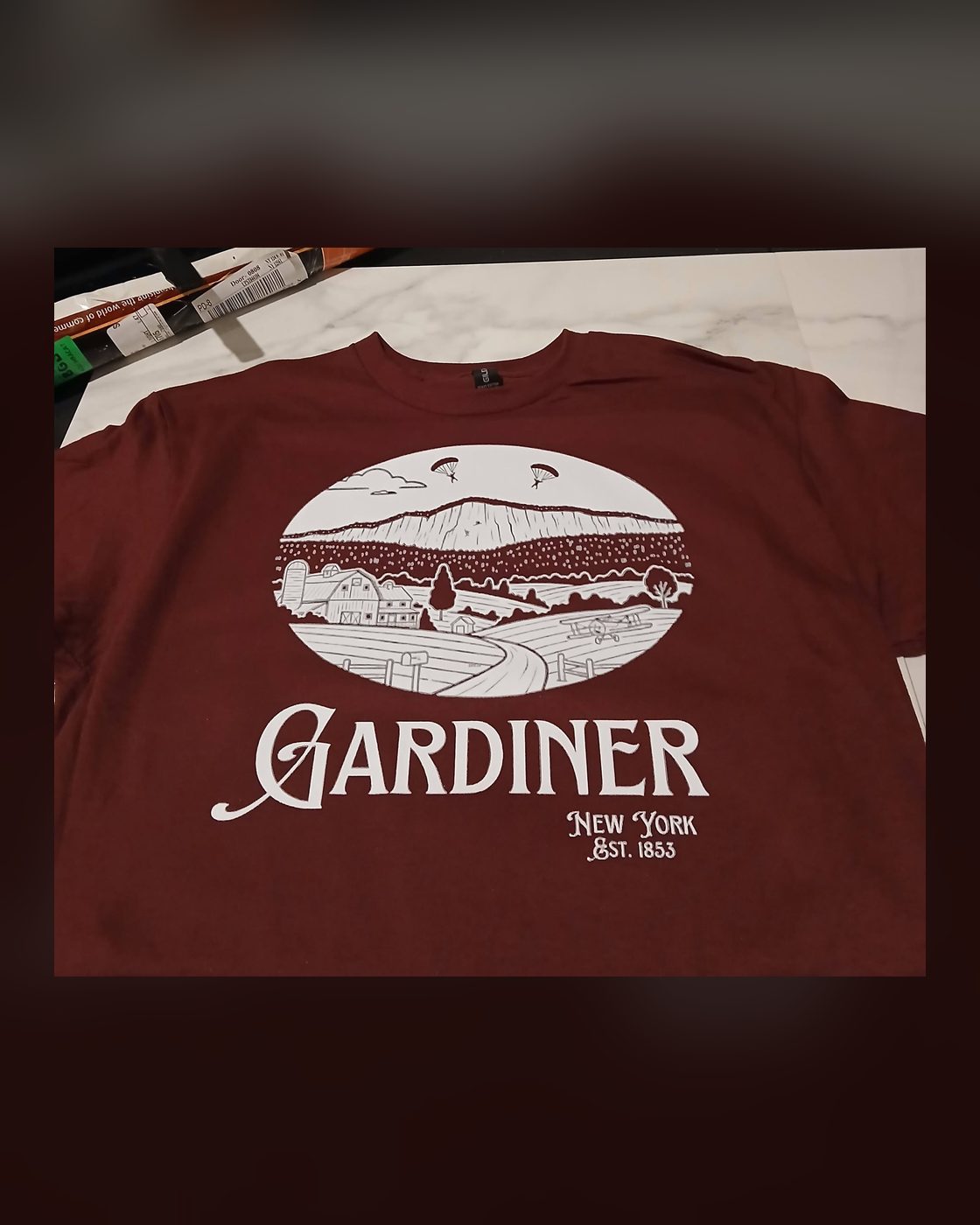 White ink Gardiner tee on maroon