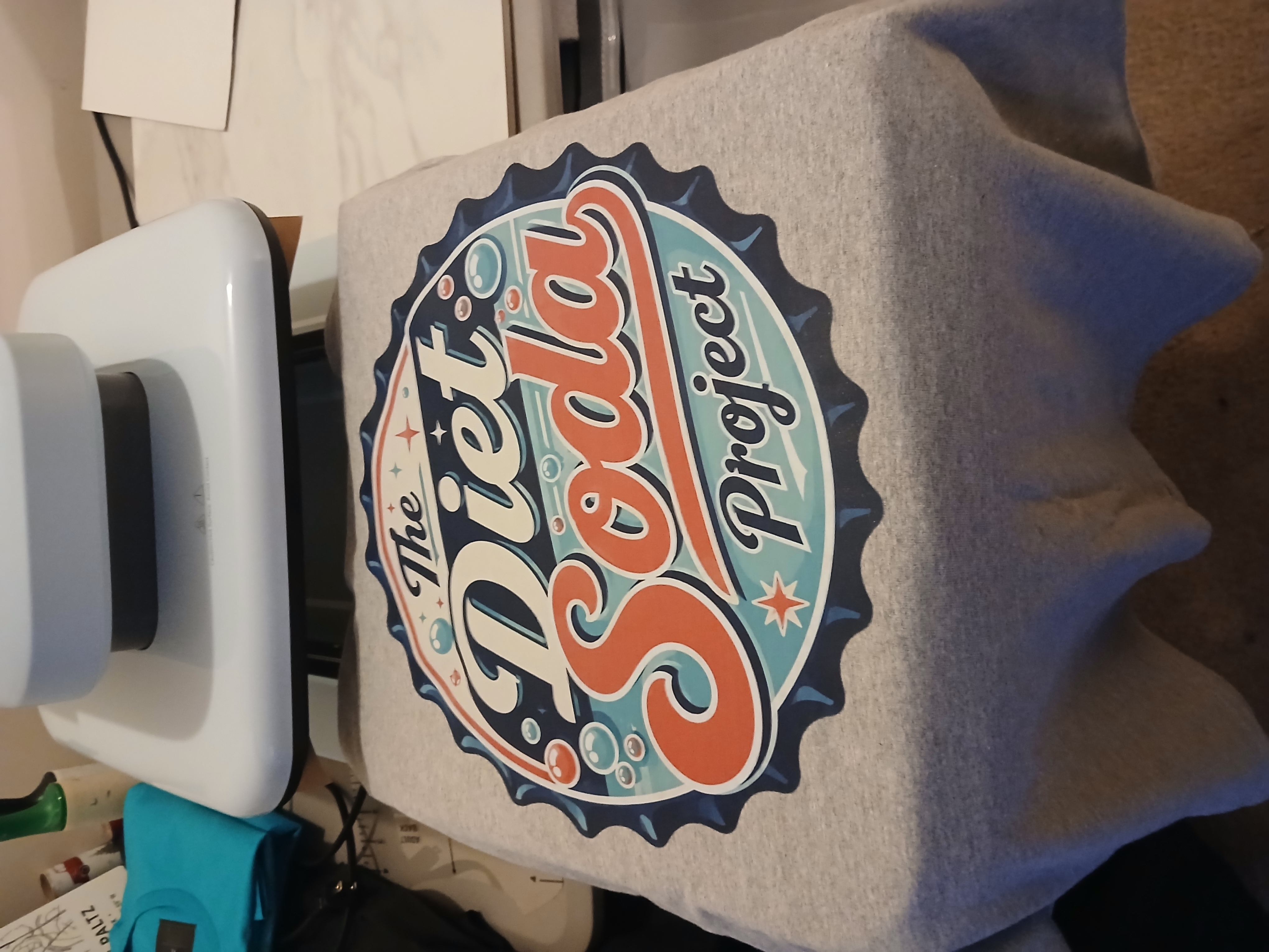Full gray Diet Soda Project shirt on the heat press